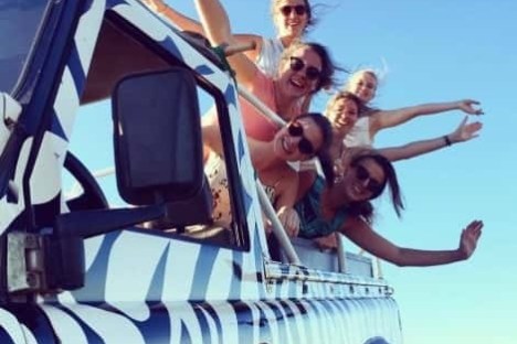 a group of people on the back of a jeep