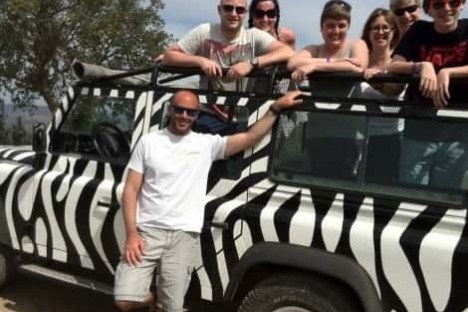 a group of people in a car posing for the camera