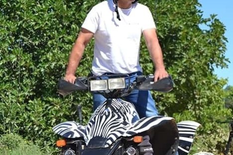 a man riding on the back of a quad bike