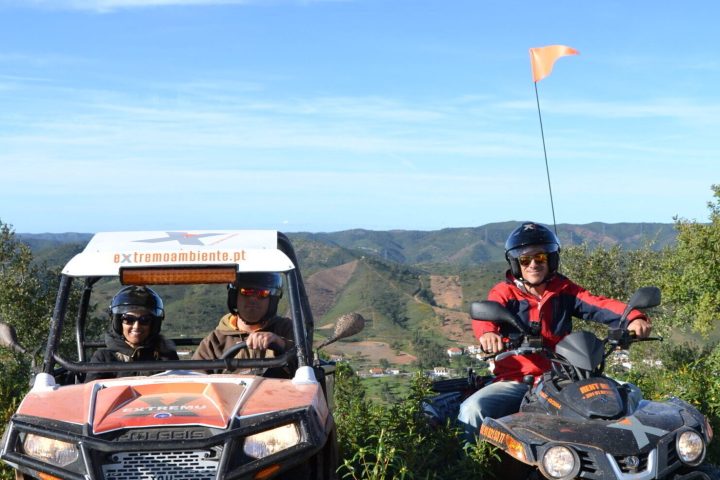 a group of people riding on a buggy and a quad bike