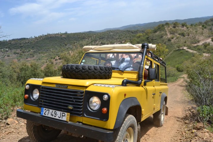 a truck driving down a dirt road