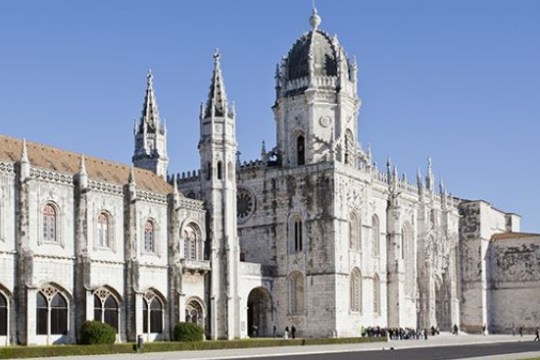 Gothic-style cathedral with ornate spires against a clear blue sky.